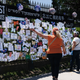 People walk by a memorial for those who have died from the coronavirus outside Green-Wood Cemetery on May 27, 2020.